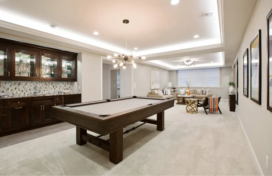 Finished basement game room with pool table and wet bar by One Stop Construction in Southern Utah